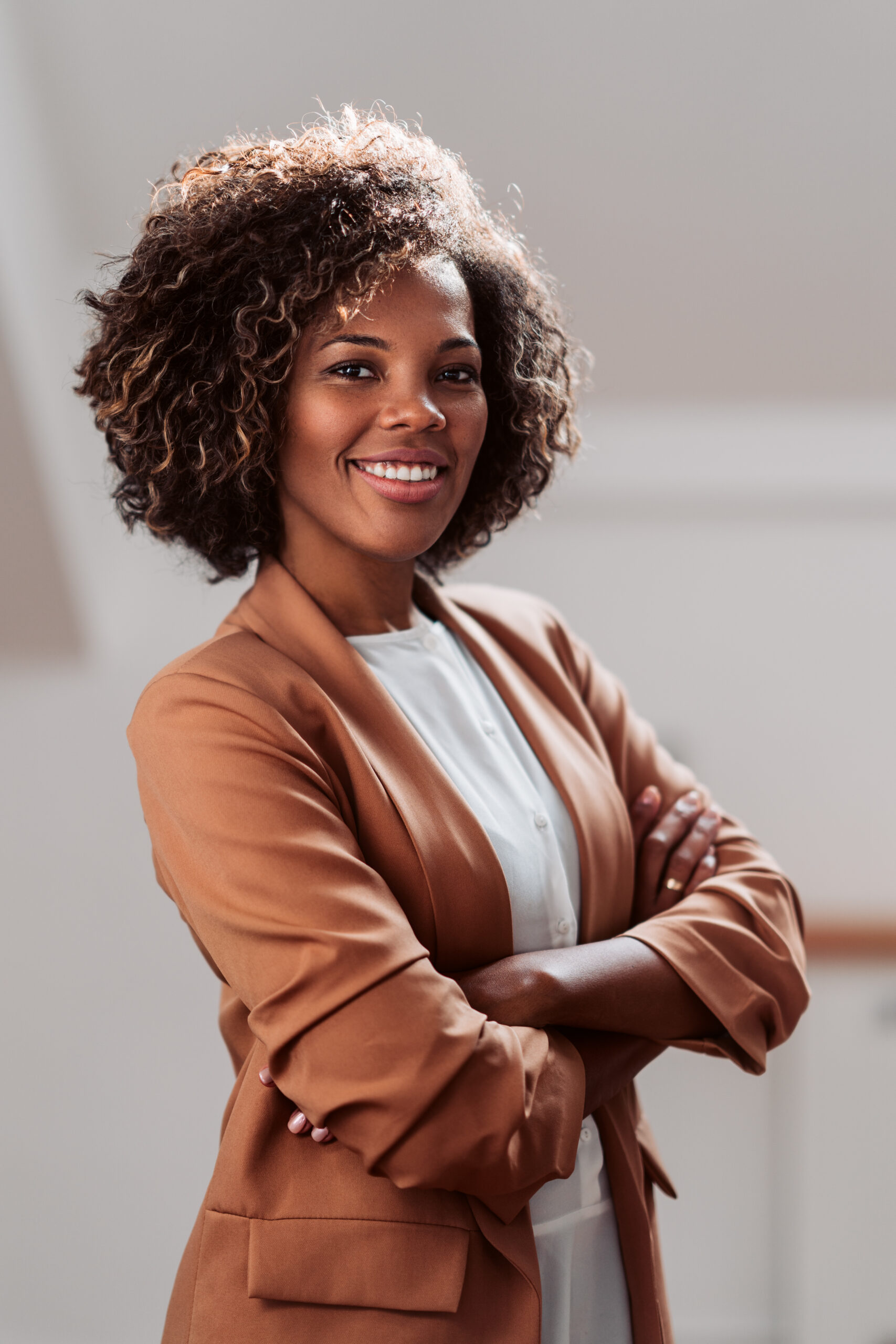 Professional woman smiling with arms crossed