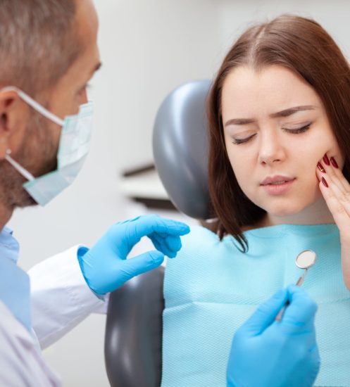 Patient with toothache at dentist