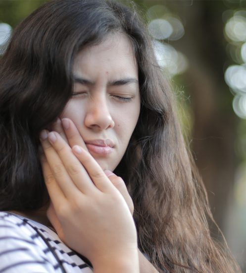 Girl in pain with chipped tooth