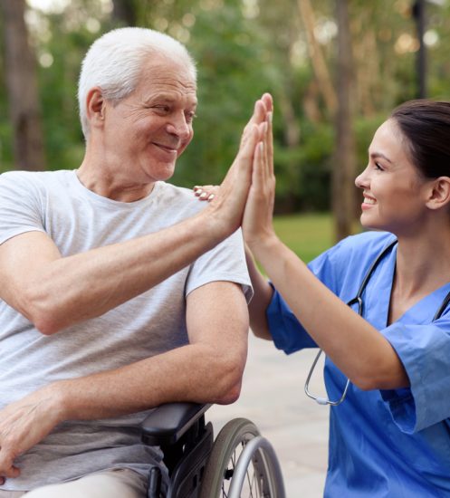 Nurse high-fiving a senior patient